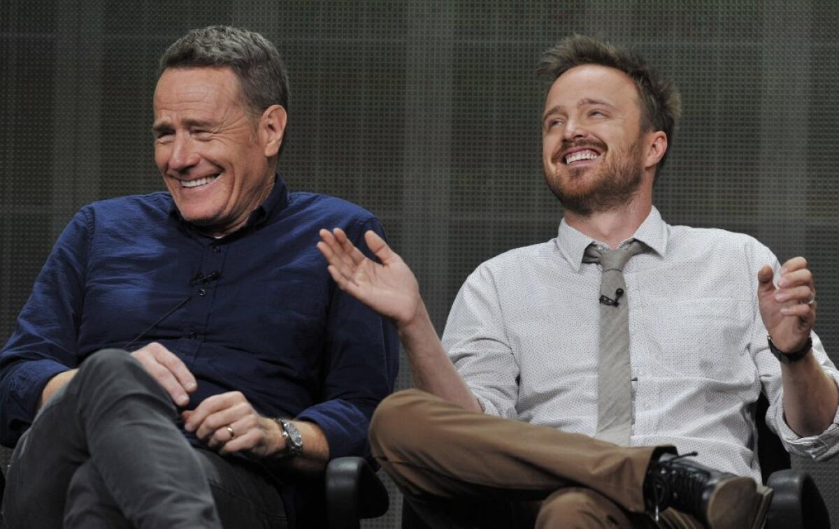 Bryan Cranston, left, and Aaron Paul, cast members in the television series "Breaking Bad," share a laugh onstage during AMC's Summer 2013 TCA press tour at the Beverly Hilton Hotel.