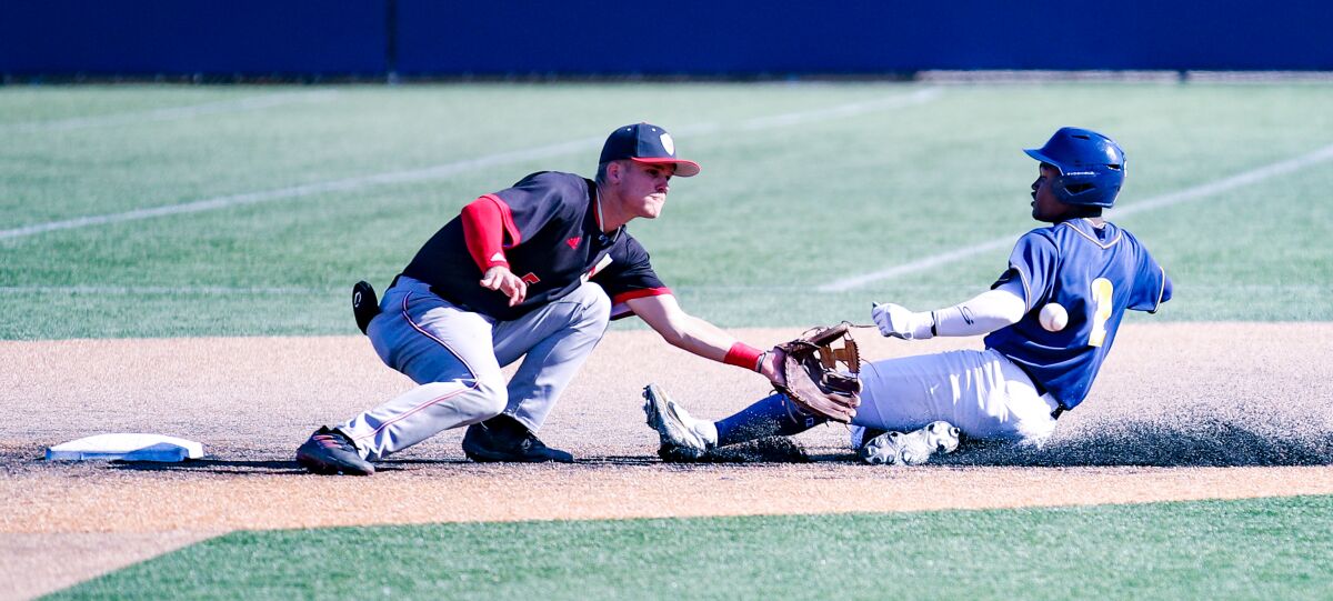 Orange Lutheran second baseman Chase Cummings waits for the ball to tag out the sliding Dean West of Sherman Oaks Notre Dame.