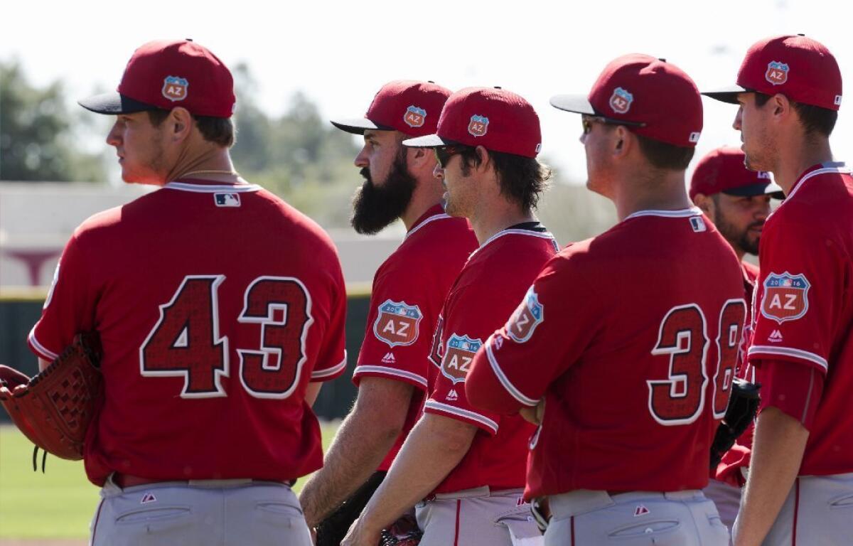 Angels pitchers watch infield drills during a spring training practice on Feb. 28.