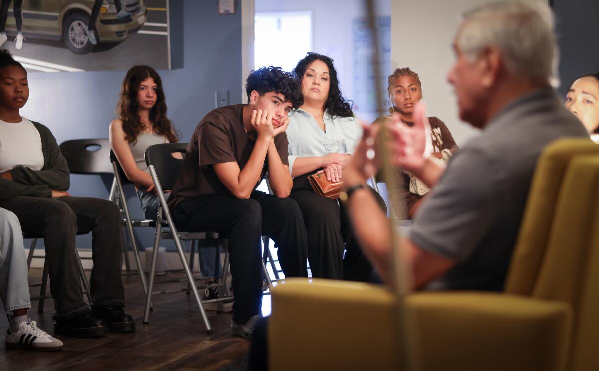 Teenagers look intently at a speaker.