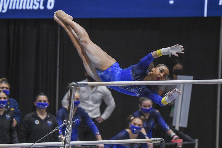 UCLA's Margzetta Frazier competes on the uneven bars in the NCAA regional final in Morgantown, W. Va., on April 3, 2021.