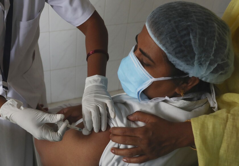 A healthcare worker receives a COVID-19 vaccine at a government Hospital in Hyderabad, India, on Monday.