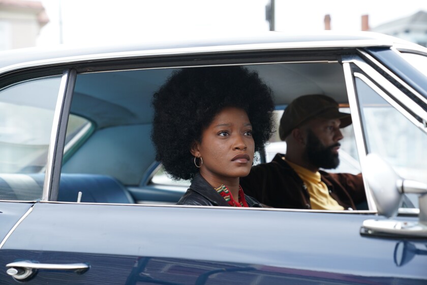 A woman and a man ride in a car in the film "Alice."