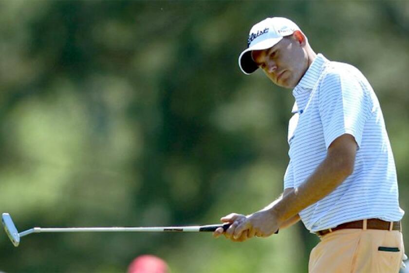 Bill Haas, the clubhouse leader with a four-under-par 68 on Thursday in the first round of the Masters, eyes his put on the 17th green at Augusta National Golf Club.