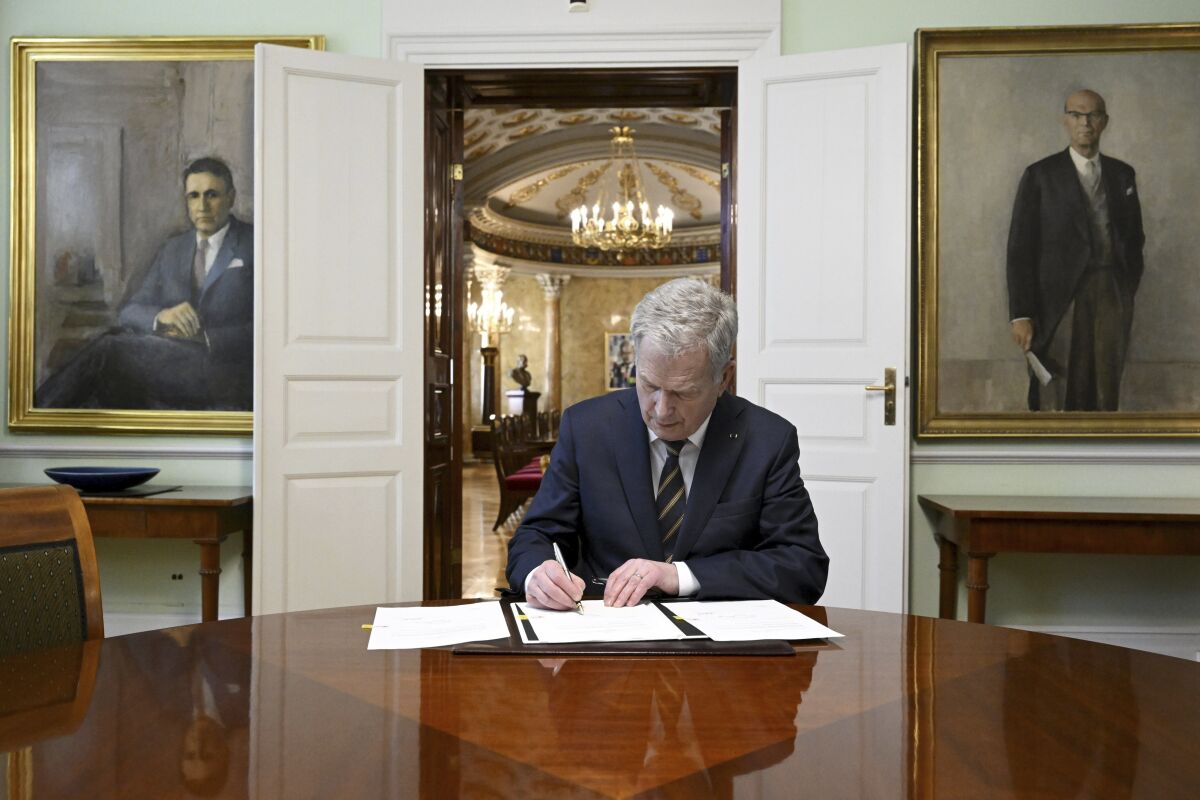 Finland's President Sauli Niinisto signs Finland's national Nato legislation in Helsinki, Finland, Thursday March 23, 2023. The Finnish president has sealed the Nordic country’s historic bid to join NATO by signing into laws the required legal amendments needed for membership in the military alliance. The president's move Thursday means Finland is now awaiting approval from Turkey and Hungary, the only two of NATO’s 30 existing members that haven’t ratified its bid. (Markku Ulander/Lehtikuva via AP)
