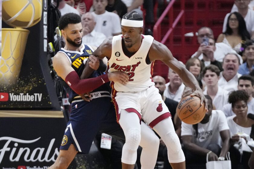 Denver Nuggets guard Jamal Murray (27) defends Miami Heat forward Jimmy Butler (22) during the first half of Game 4 of the basketball NBA Finals, Friday, June 9, 2023, in Miami. (AP Photo/Wilfredo Lee)
