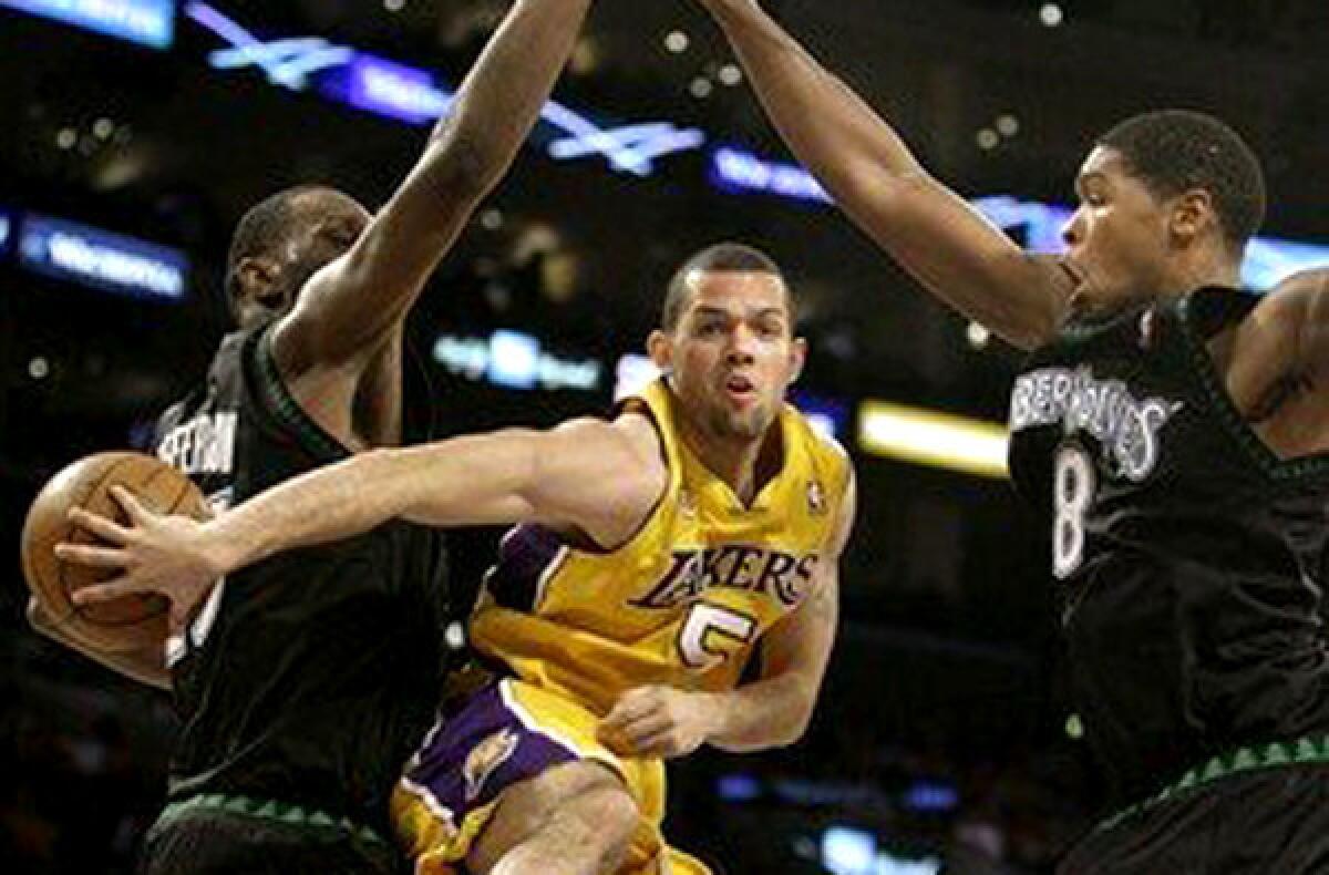 Jordan Farmar makes a no-look pass between Timberwolves defenders during a game with the Lakers in 2011.