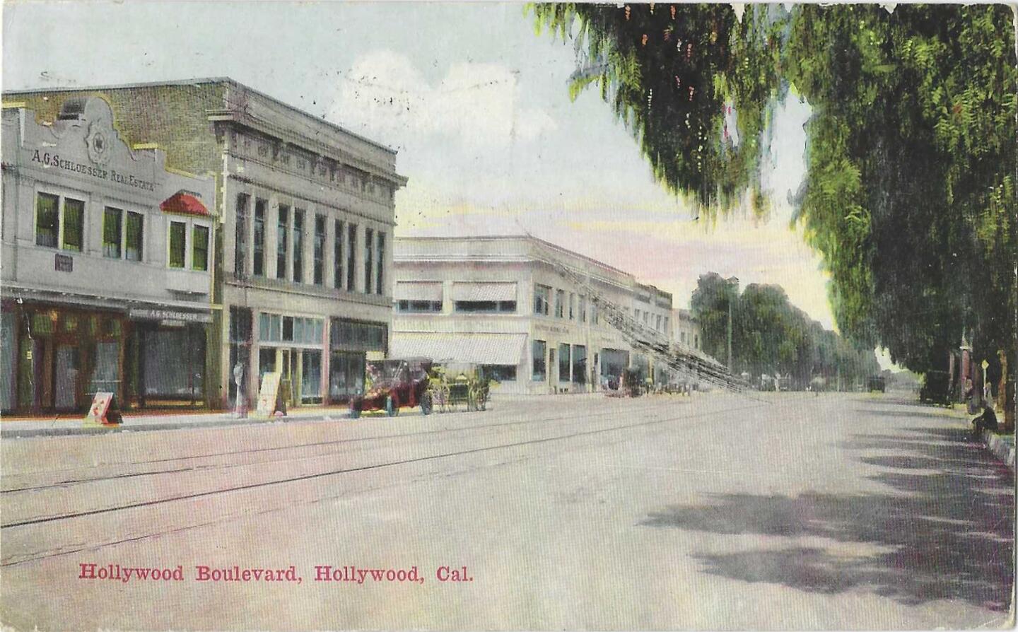 A vintage postcard shows a nearly empty Hollywood Boulevard