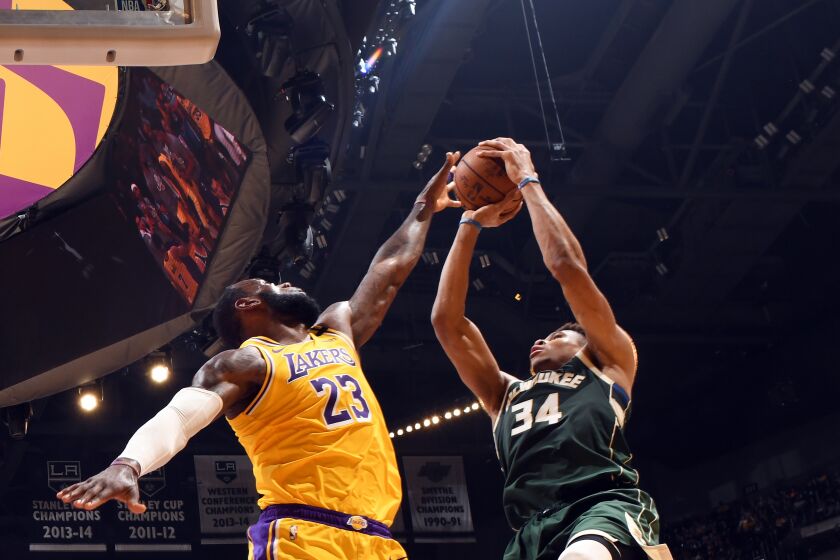 Lakers' LeBron James attempts to block a shot by Milwaukee Bucks' Giannis Antetokounmpo on March 6 at Staples Center.