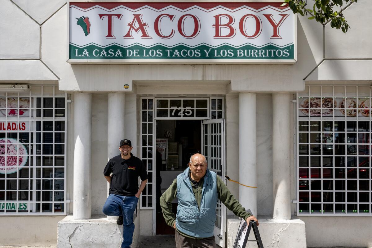 Samuel Solis, front, and his son Samuel Solis Jr., in front of their family-owned restaurant Taco Boy.