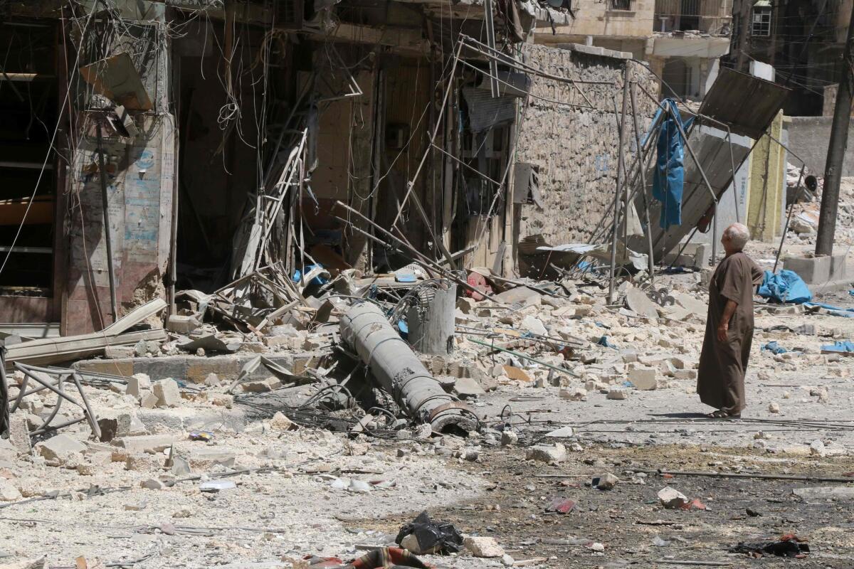 A resident of the Tariq al-Bab neighborhood of Aleppo on Aug. 16, 2016, inspects the damage caused by air raids that reportedly targeted rebel-held areas in the northern city.