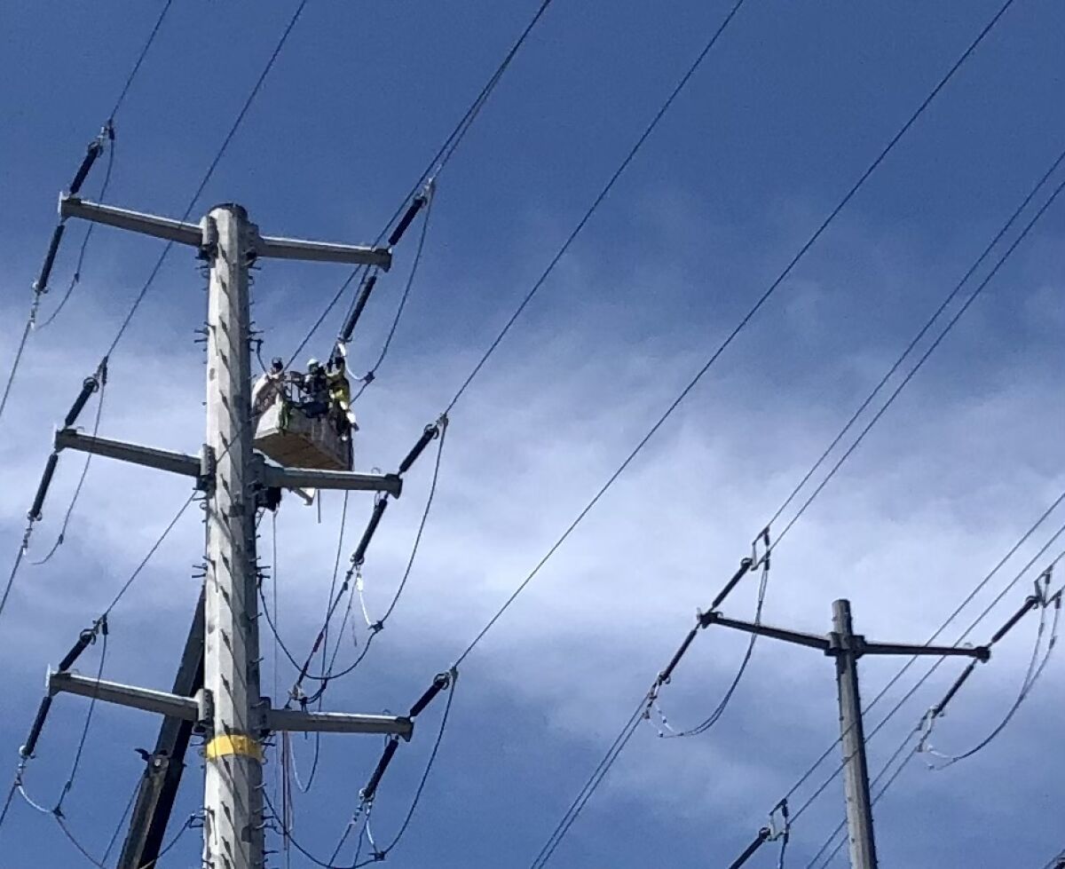 A crew works on a San Diego Gas & Electric power in Tierrasanta in July.