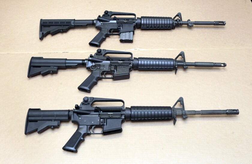 Three variations of AR-15 rifles are displayed at the California Department of Justice.