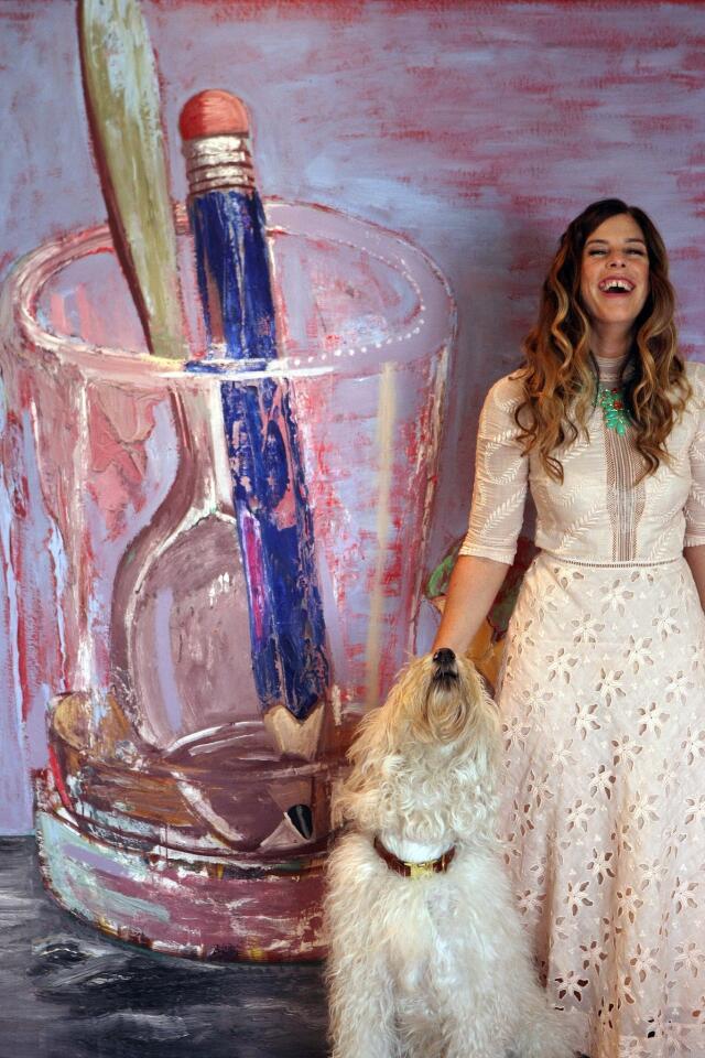 Jewelry designer Irene Neuwirth, with her dog Teddy, at her offices on Abbot Kinney Boulevard in Venice on June 10, 2013. Neuwirth's company has evolved into one of the leading new American fine jewelry brands. Neuwirth was photographed against a painting by Martin Lubner.