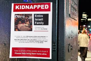 A flier on an electrical box with the words "Kidnapped: Entire Israeli family" and a photo