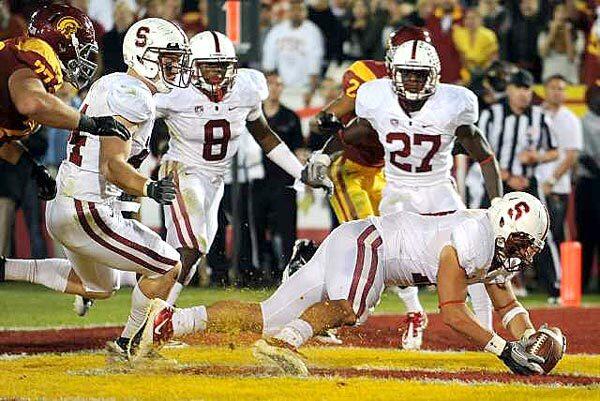 Stanford linebacker A.J. Tarpley recovers a fumble by USC running back Curtis McNeal in the end zone to seal a 56-48 victory over the Trojans in three overtimes Saturday at the Coliseum.