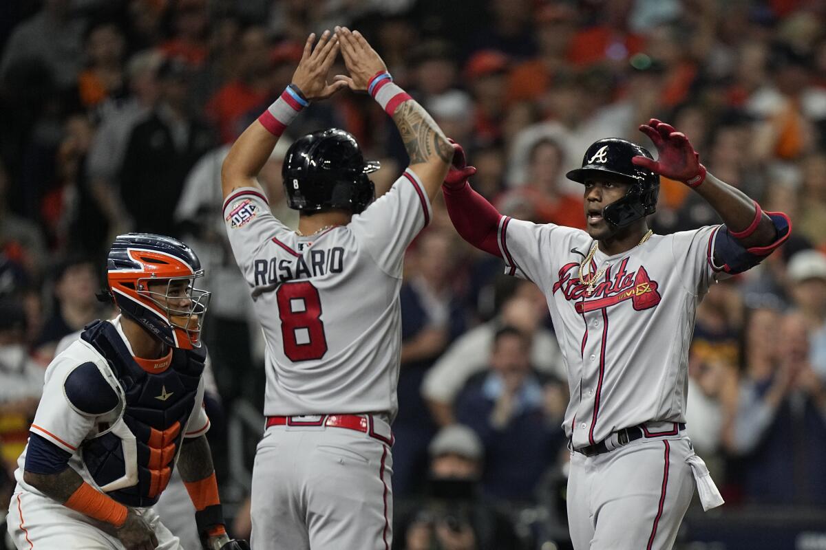 Atlanta's Jorge Soler celebrates a three-run home run with Eddie Rosario.