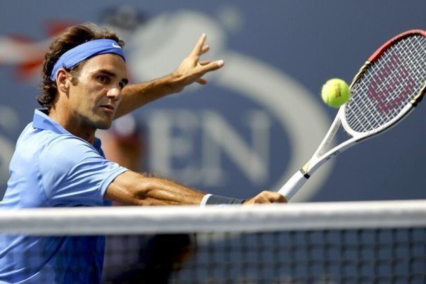 Roger Federer reaches for a volley during a second-round match against Carlos Berlocq on Thursday at the U.S. Open.