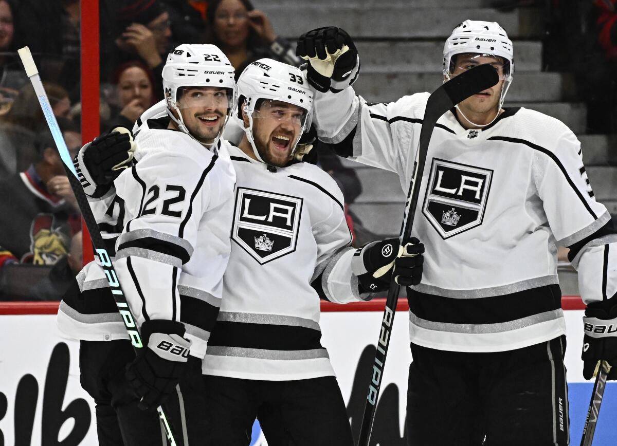 Los Angeles Kings right wing Viktor Arvidsson celebrates scoring his second goal of the game against the Ottawa Senators with teammates Kevin Fiala (22) and Matt Roy during the first period of an NHL hockey game, Tuesday, Dec. 6, 2022, in Ottawa, Ontario. (Justin Tang/The Canadian Press via AP)