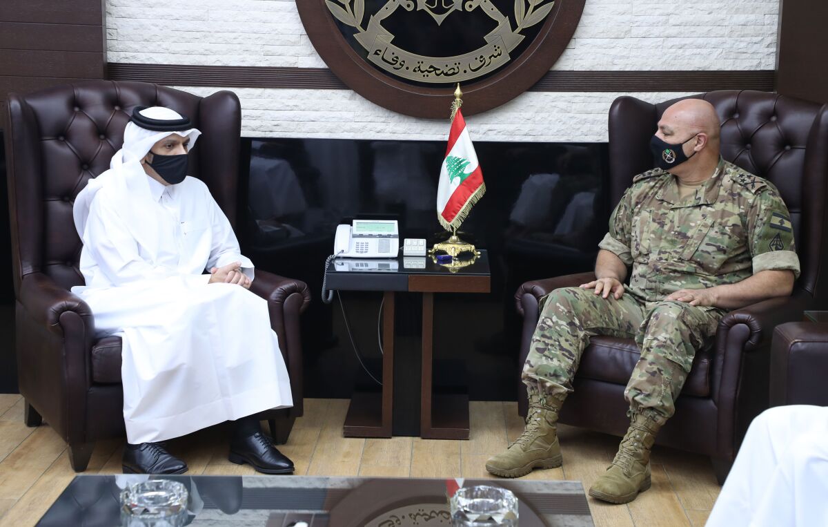 In this photo released by the Lebanese Army official website, Lebanese Army Commander Gen. Joseph Aoun, right, meets with Qatar's Deputy Prime Minister and Foreign Minister Sheikh Mohammed bin Abdulrahman bin Jassim Al-Thani, at the defense ministry, in Beirut, Lebanon, Tuesday, July 6, 2021. Qatar's Foreign Minster is in Beirut for one day visit to meet with Lebanese officials. (Lebanese Army Website via AP)
