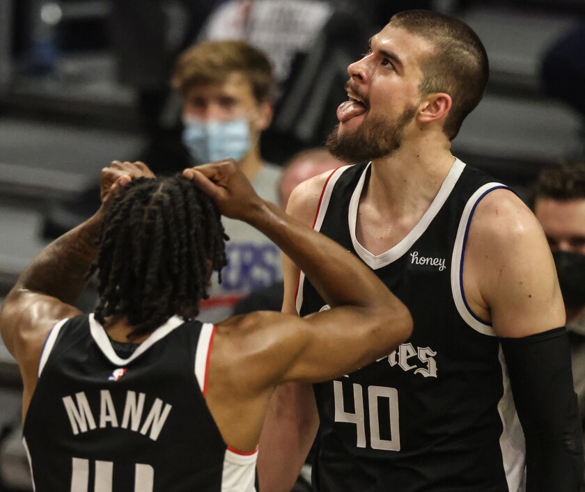 Clippers center Ivica Zubac (40) and teammate Terance Mann react after Zubac was fouled in Game 3.