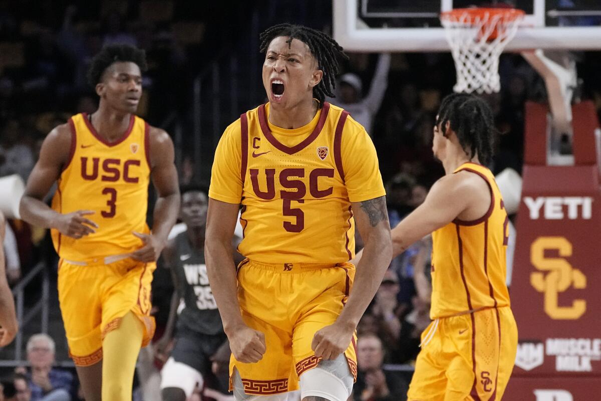 Southern California guard Boogie Ellis, center, celebrates after scoring during the first half.