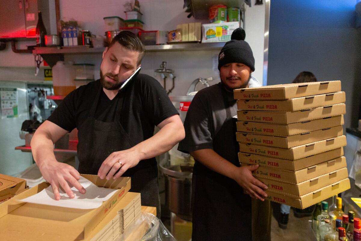 Daniel Cutler, left, and Jesse Soto prepare for Ronan's first night of takeout and delivery only.