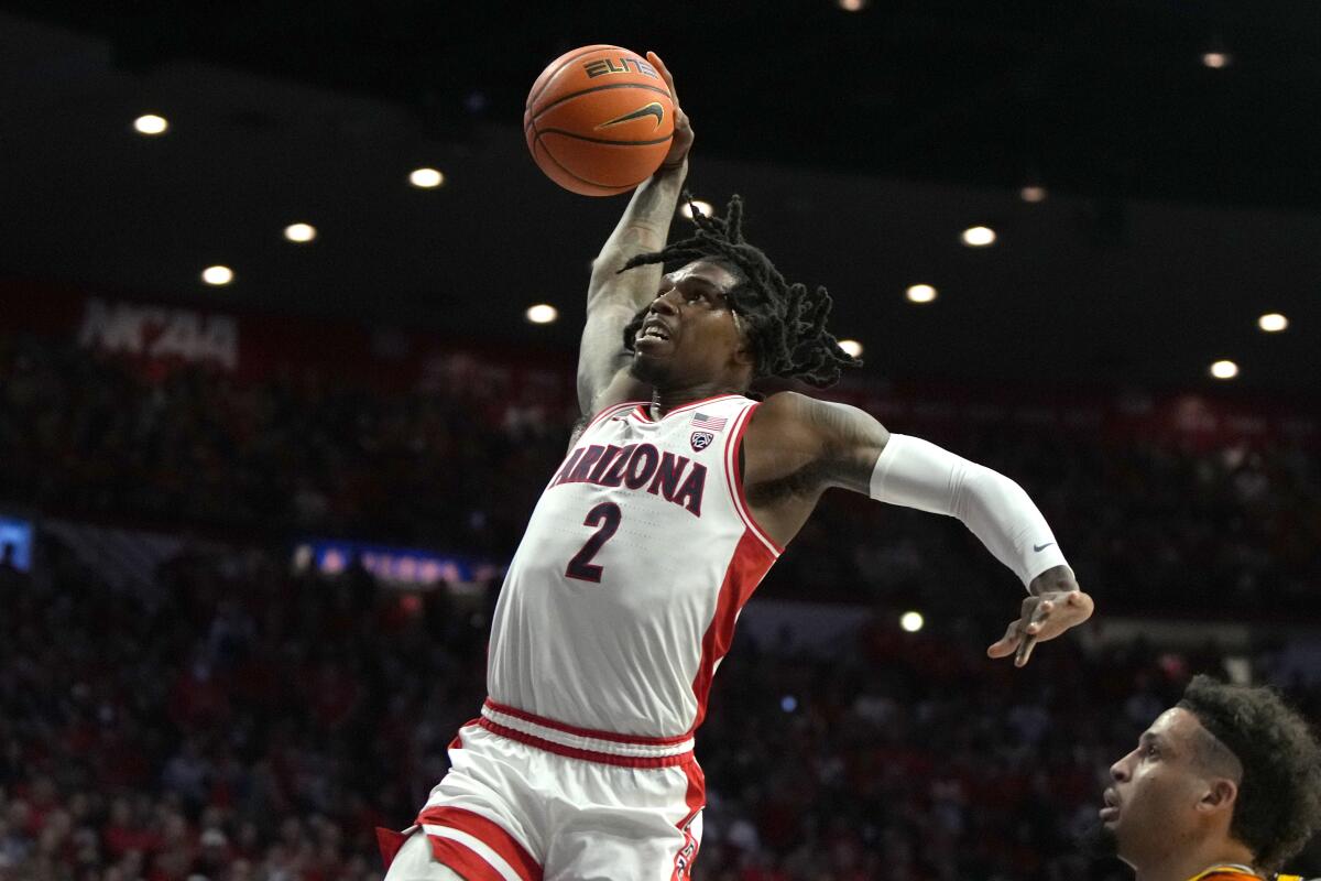 Arizona guard Caleb Love dunks against Arizona State on Feb. 17.