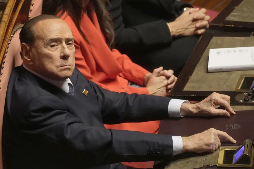 Silvio Berlusconi takes his seat in the Italian Senate on the opening session of the new parliament on Oct. 13, 2022. 
