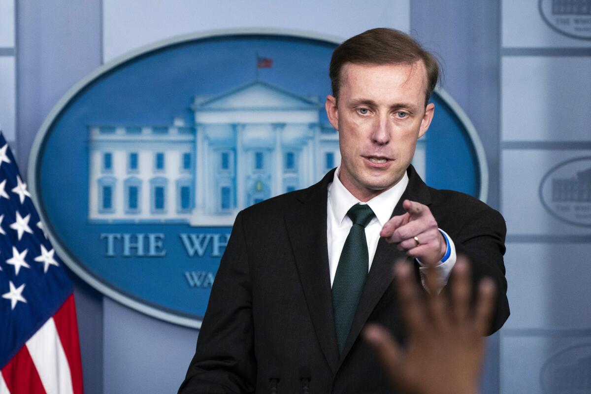 White House national security advisor Jake Sullivan points to a reporter raising a hand to ask a question