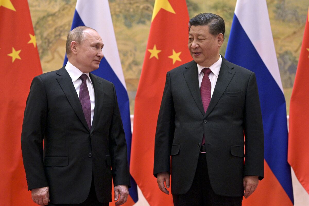 FILE - Chinese President Xi Jinping, right, and Russian President Vladimir Putin talk to each other during their meeting in Beijing, Feb. 4, 2022. China on Thursday, March 3, 2022, denounced a report that it asked Russia to delay invading Ukraine until after the Beijing Winter Olympics as "fake news" and a "very despicable" attempt to divert attention and shift blame over the conflict. (Alexei Druzhinin, Sputnik, Kremlin Pool Photo via AP, File)