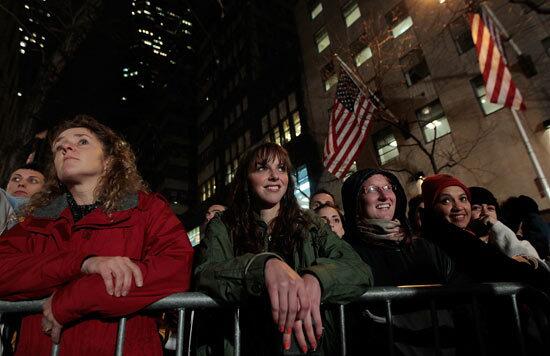 Spectators wait for the lighting of the Rockefeller Center Christmas tree.