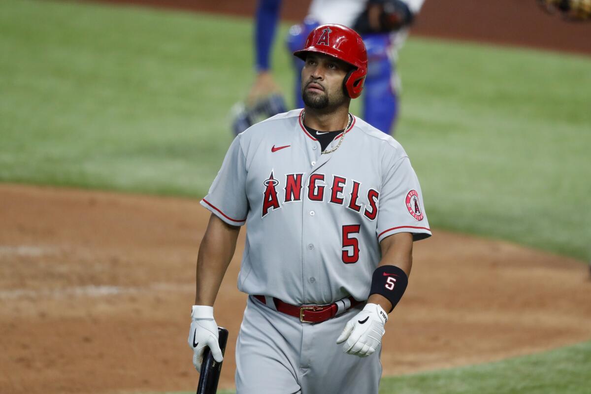 Albert Pujols walks to the dugout after fouling out.