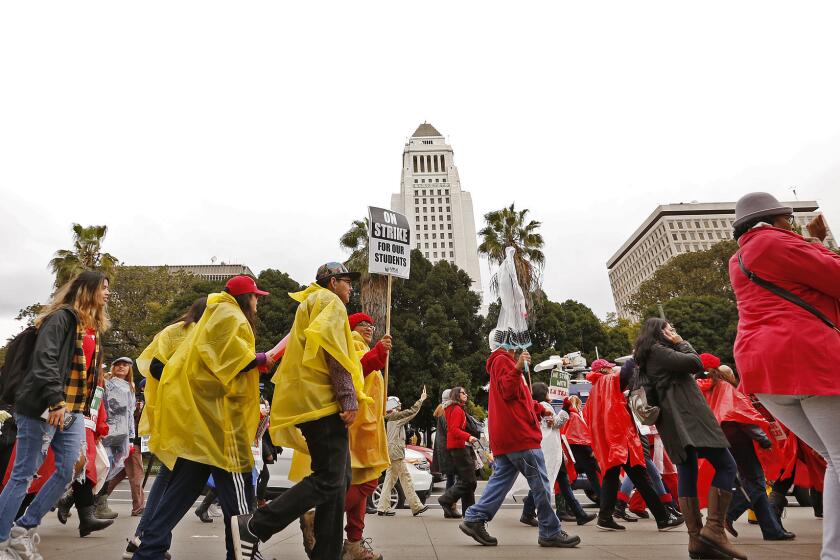 LOS ANGELES, CA - JANUARY 15, 2019 Teachers and supporters make their way through downtown Los Angeles to attend a rally at the California Charter Schools Association in downtown Los Angeles on Tuesday morning, the second day of the Los Angeles school teachers strike January 15, 2019. (Al Seib / Los Angeles Times)