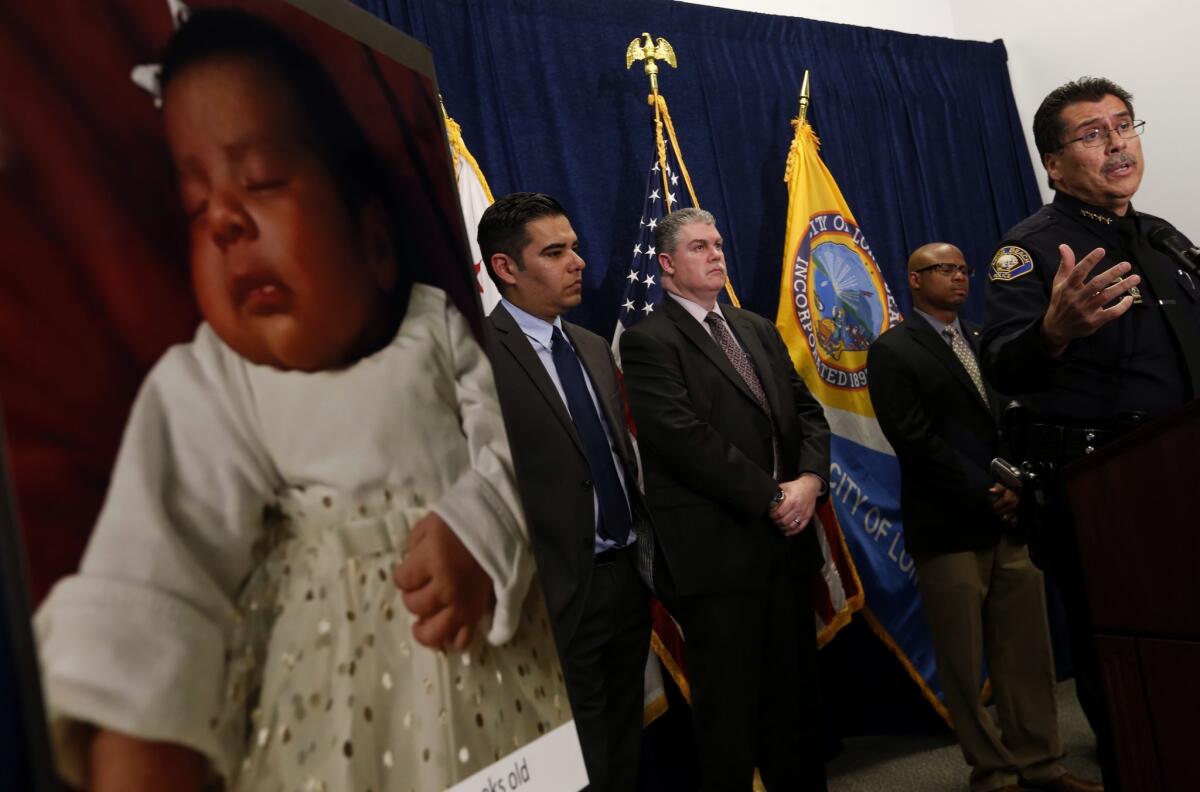 Long Beach Mayor Robert Garcia, left, Lt. Lloyd Cox and City Councilman Al Austin listen to Long Beach Police Chief Robert Luna announce the arrest of multiple suspects in connection with the Jan. 3 kidnapping and murder of 3-week-old Eliza Delacruz, shown in photo at far left.