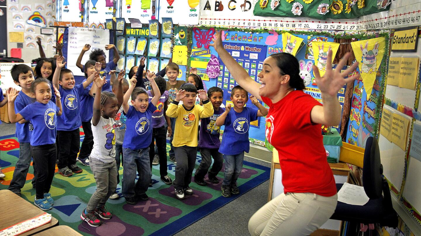 Teacher Adriana Rosas leads kindergarten students reciting nutrition chants at Aloha Health Medical Academy in Lakewood. The campus is part of the ABC Unified School District, which also serves Hawaiian Gardens.