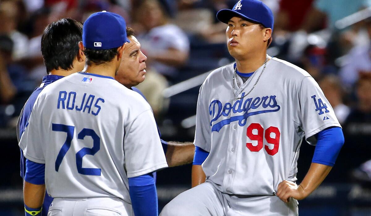 Dodgers starting pitcher Hyun-Jin Ryu (99) is examined after injuring himself in the sixth inning of a game against the Braves on Wednesday night in Atlanta.