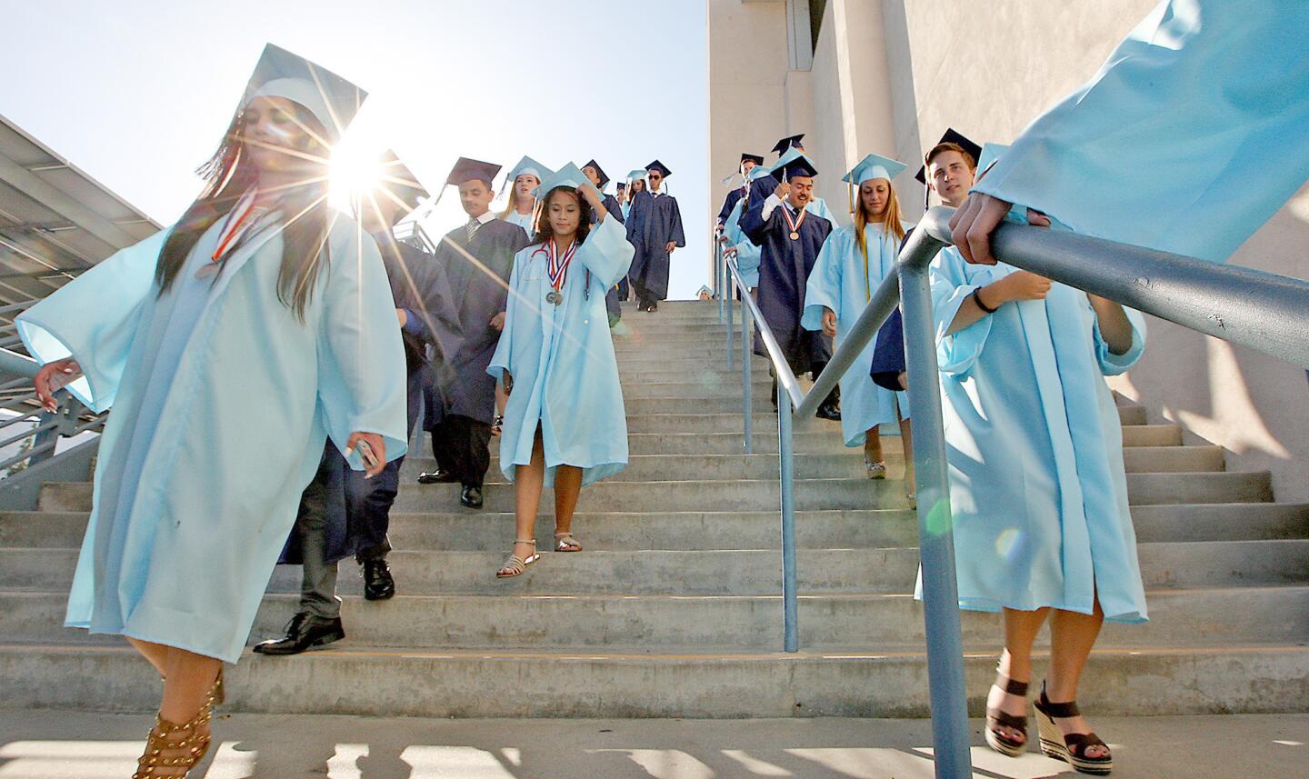 Graduates make their way from the gym to the football field for the Crescenta Valley High graduation ceremony on Tuesday, June 3, 2014.