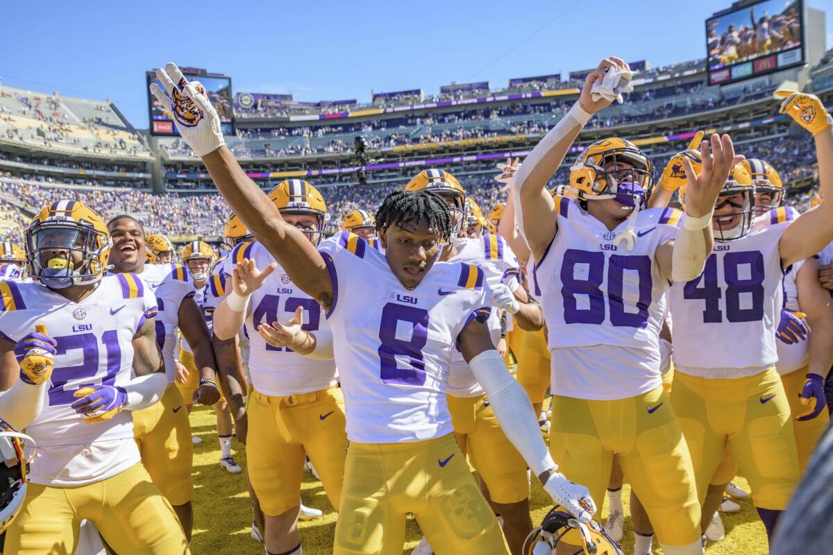 LSU football players dance in the sunlight.