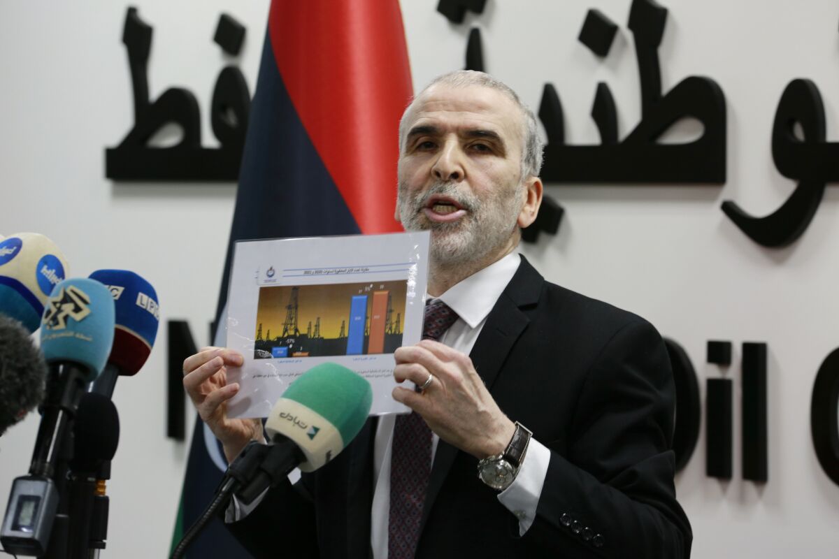 Chairman of the Libyan National Oil Corporation Mustafa Sanallah holds a chart during a press conference about the state of the country’s oil production, at the corporation’s headquarters in Tripoli, Libya, July 11, 2022. A power struggle has emerged between Sanallah and one of Libya’s rival prime ministers Abdel Hamid Dbeibah, who leads the country’s Tripoli-based government. Dbeibah has dismissed the chairman, but Sanallah has refused to leave office. (AP Photo/Yousef Murad)