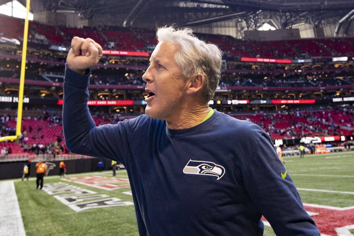 Seahawks coach Pete Carroll celebrates with the crowd.