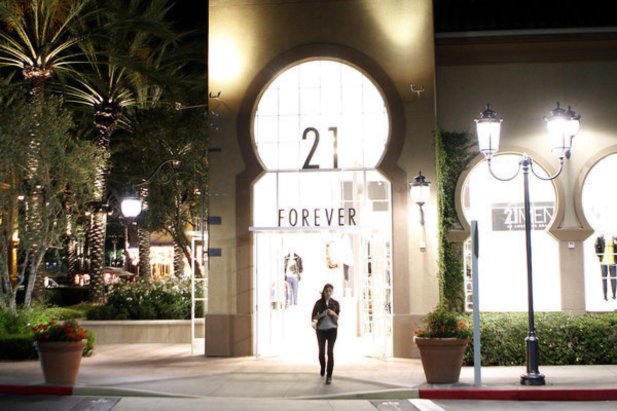 A woman walks out of a store at the Irvine Spectrum shopping center.