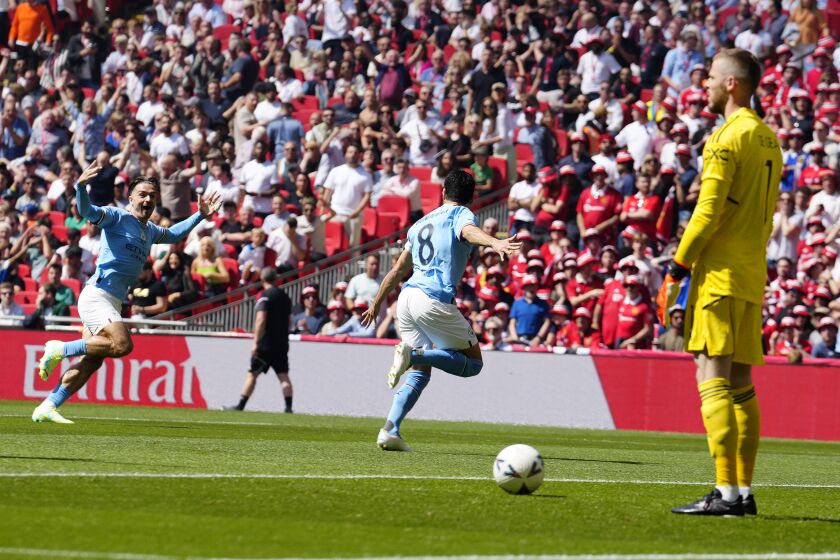 Manchester City's Ilkay Gundogan, centre, celebrates after scoring his side's first goal during the English FA Cup final soccer match between Manchester City and Manchester United at Wembley Stadium in London, Saturday, June 3, 2023.(AP Photo/Jon Super)