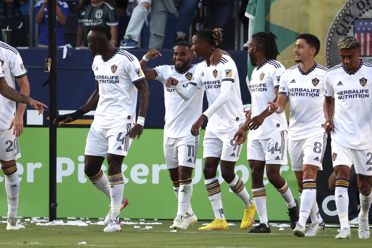 Galaxy midfielder Samuel Grandsir (11), middle left, rejoices with teammates after he scored a goal Aug. 13, 2022.