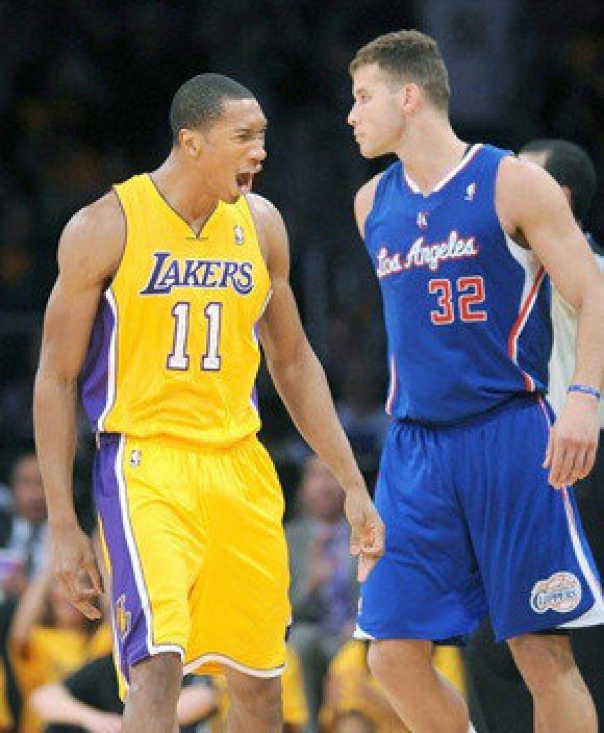 Wesley Johnson, left, celebrates in front of Blake Griffin after hitting a three-pointer during the Lakers' 116-103 season-opening victory over the Clippers.