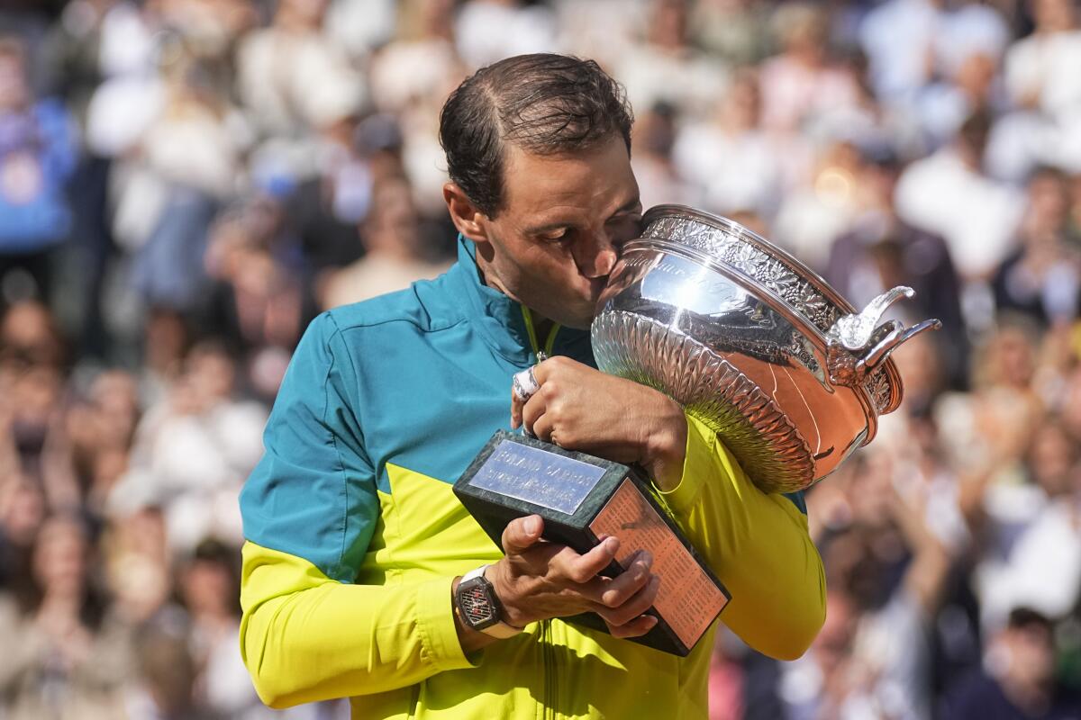 French Open champion Rafael Nadal kisses the trophy.