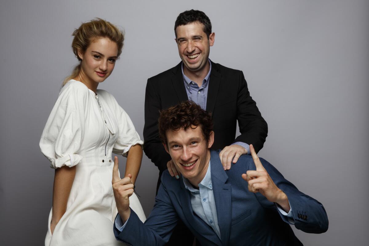 Actress Grace Van Patten, director Adam Leon, standing, and actor Callum Turner, from the film "Tramps, in the L.A. Times photo studio at the 41st Toronto International Film Festival.