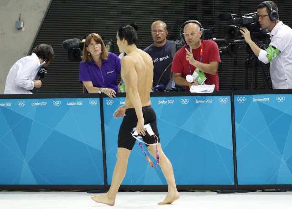 Tae-Hwan Park of South Korea walks away from the swim area after being disqualified. He was later reinstated.