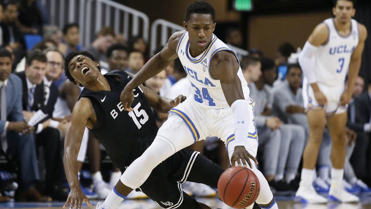 UCLA guard David Singleton tries to keep the ball away from Long Beach State guard Deishuan Booker during the second half of their game Nov. 9.