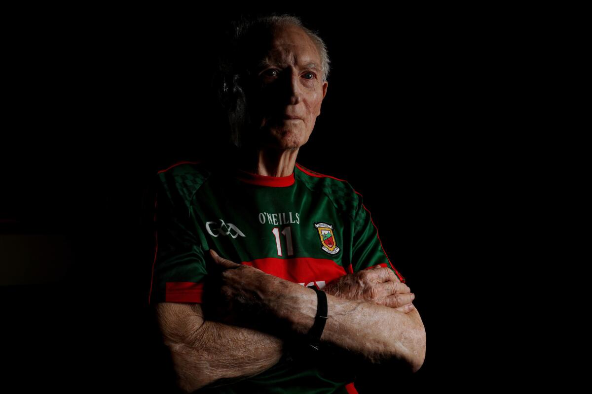 Padraig Carney, 90, wears a replica of the Gaelic football jersey he wore in the 1950s.